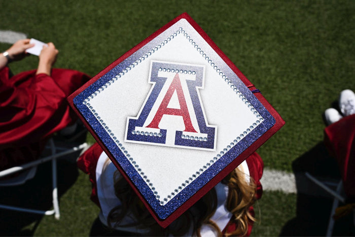 Graduate wearing Arizona A cap at field ceremony