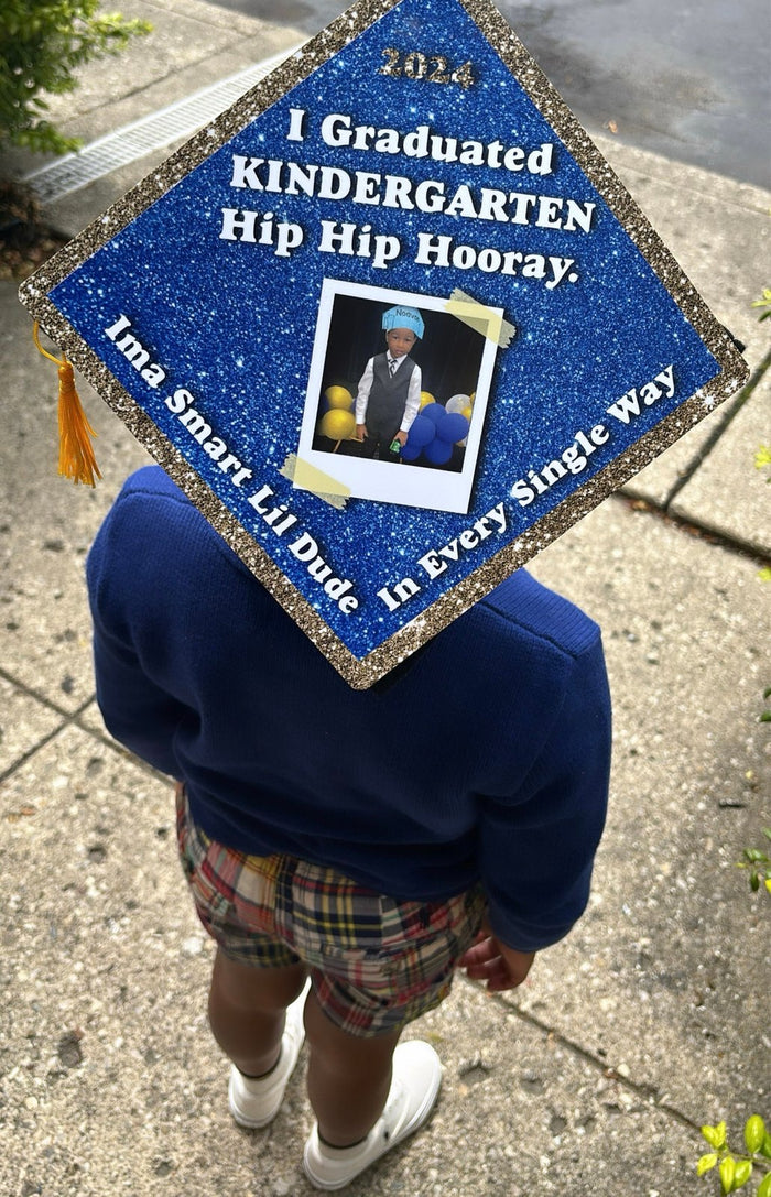 Child wearing I Graduated Kindergarten photo cap