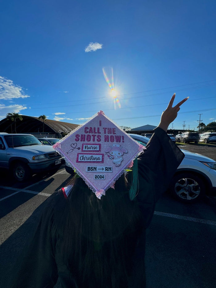 Graduate wearing Call The Shots Now nurse cap