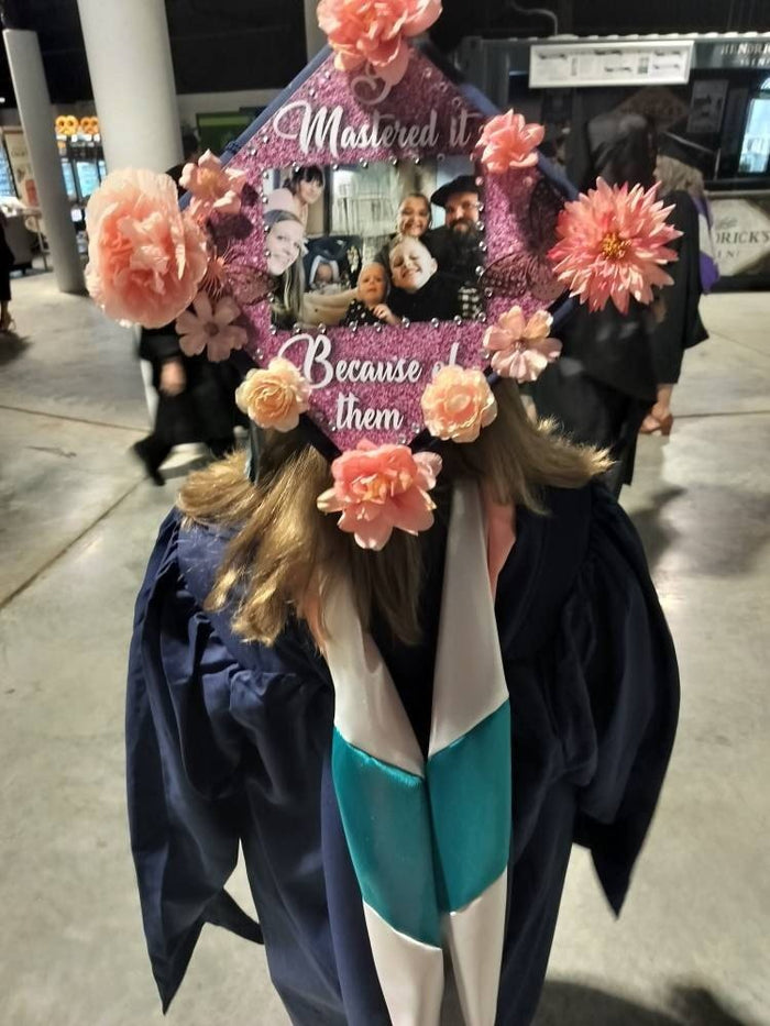 Graduate wearing floral Mastered It cap