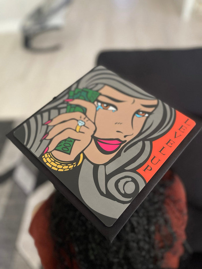 Graduate wearing Level Up pop art money cap
