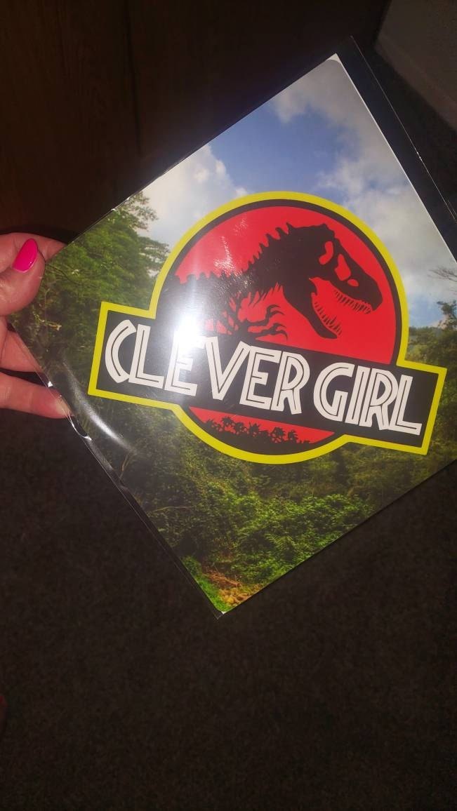 Hand holding Jurassic Clever Girl topper
