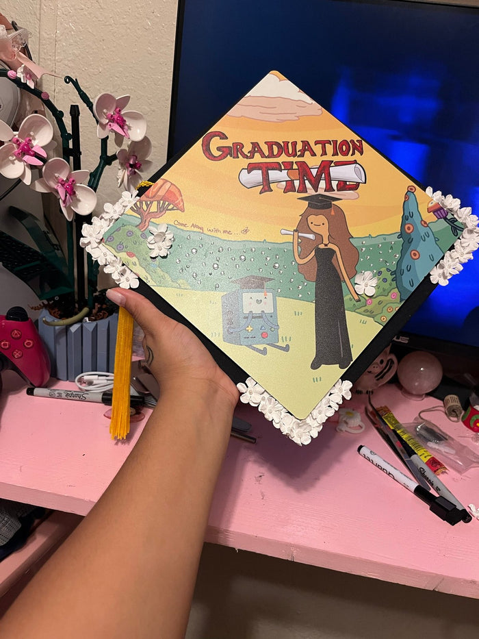 Arm holding Adventure Time Graduation Time topper