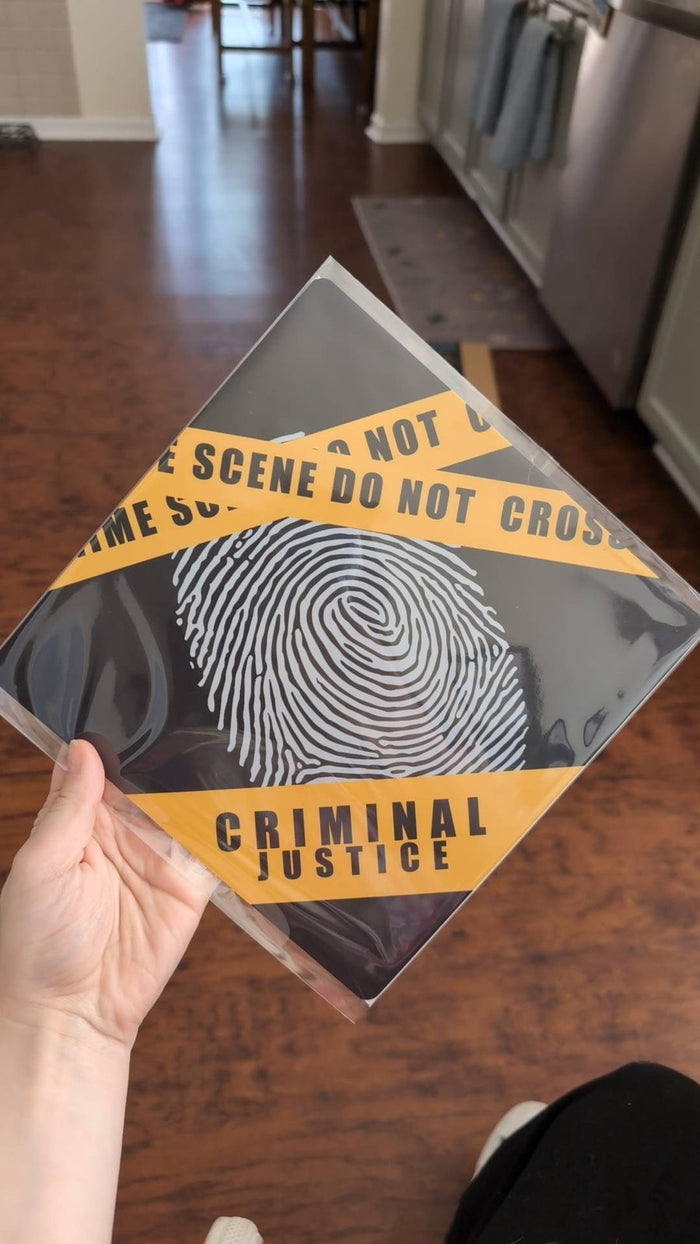 Hand holding criminal justice fingerprint topper