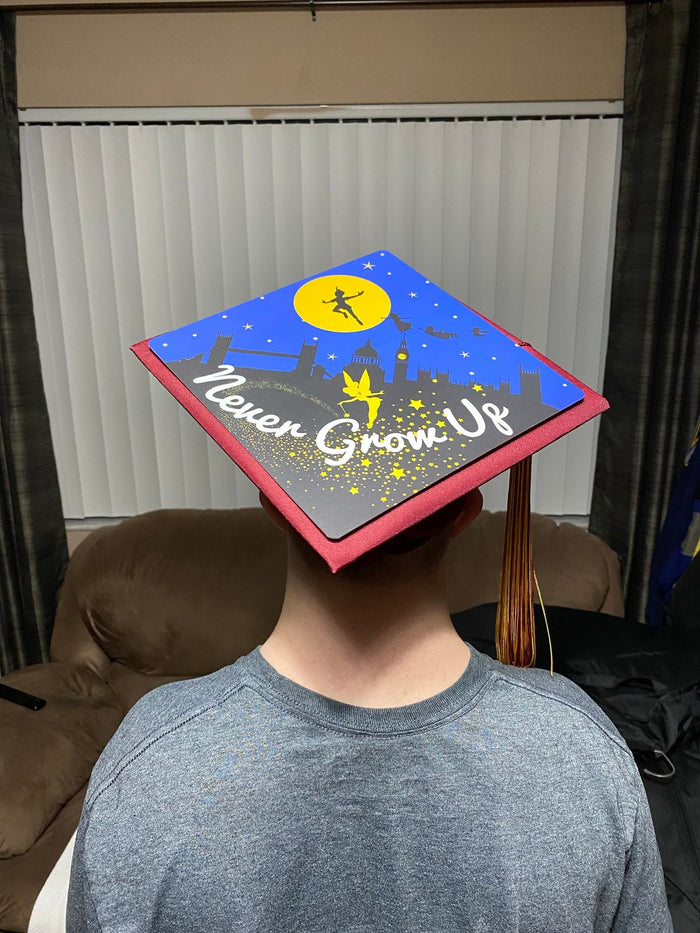 Boy wearing Peter Pan Never Grow Up cap