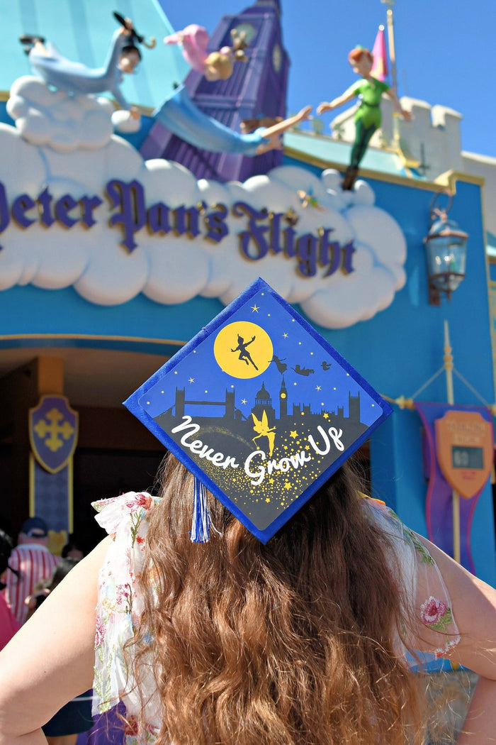 Woman wearing Peter Pan Never Grow Up cap at Disney ride