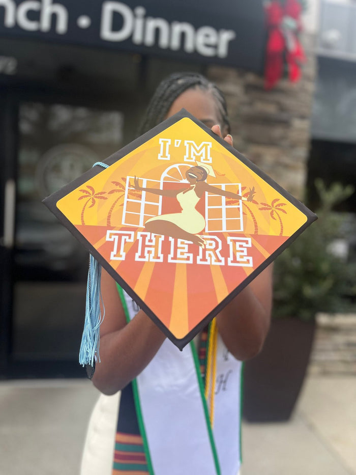 Young woman holding Im There Tiana cap