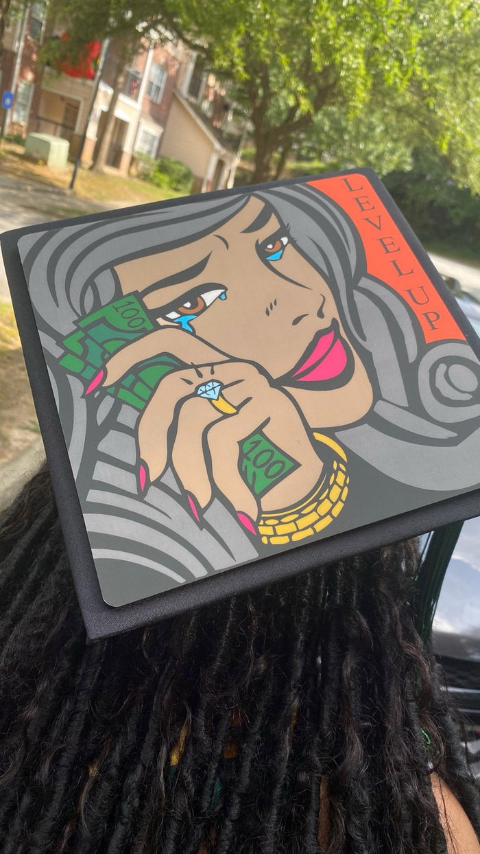 Graduate wearing Level Up pop art cap
