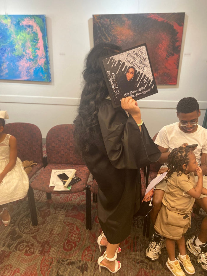 Woman in gown holding photo topper indoors