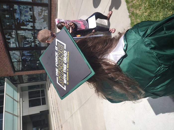 Graduate wearing Force Is Strong cap on campus