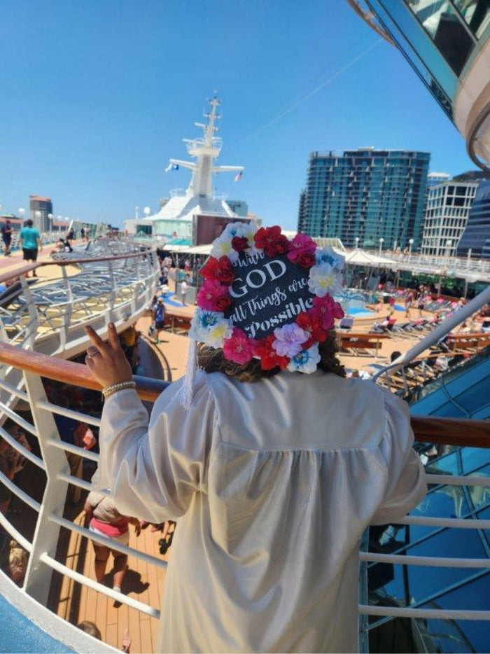 Woman wearing floral With God cap on cruise ship