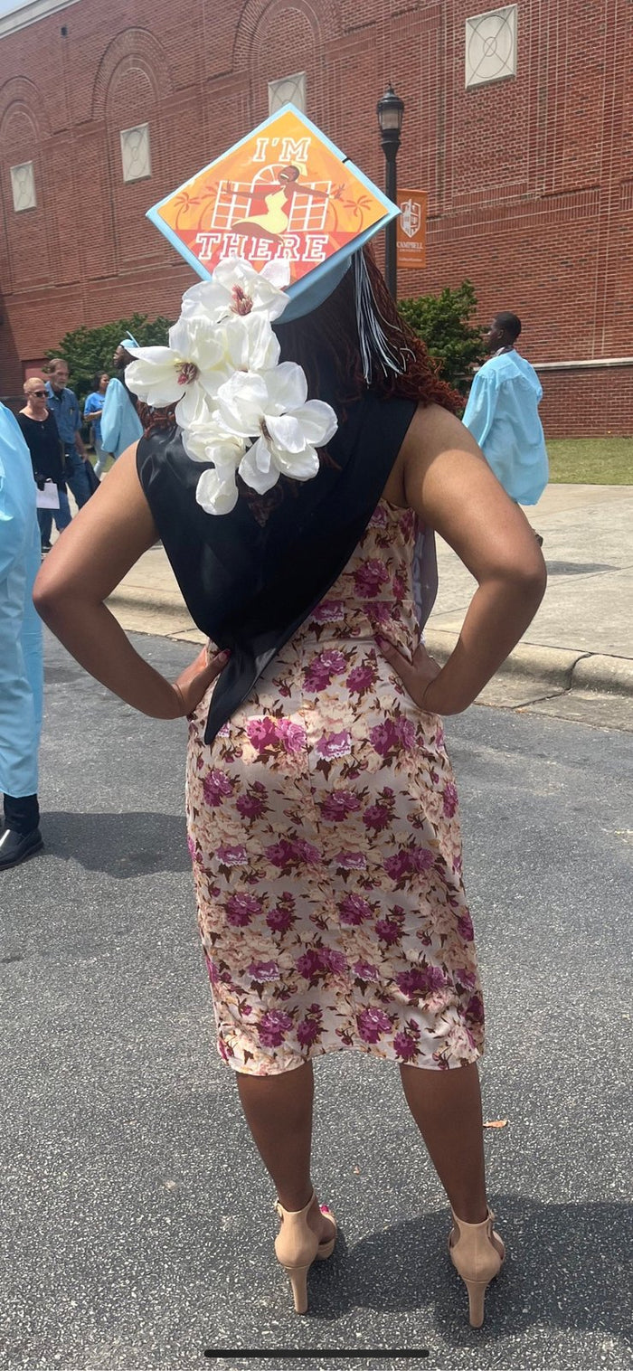 Woman wearing Im There Tiana cap with white flowers