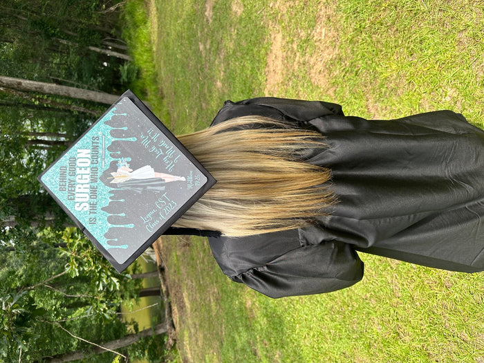 Graduate wearing Surgeon cap on grass
