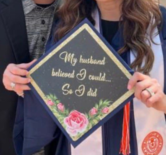 Graduate holding My Husband Believed I Could cap