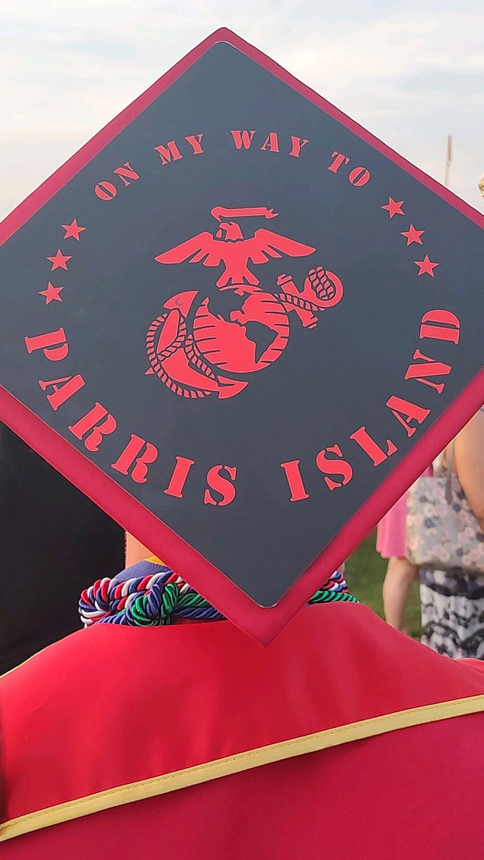 Graduate wearing Parris Island Marines cap
