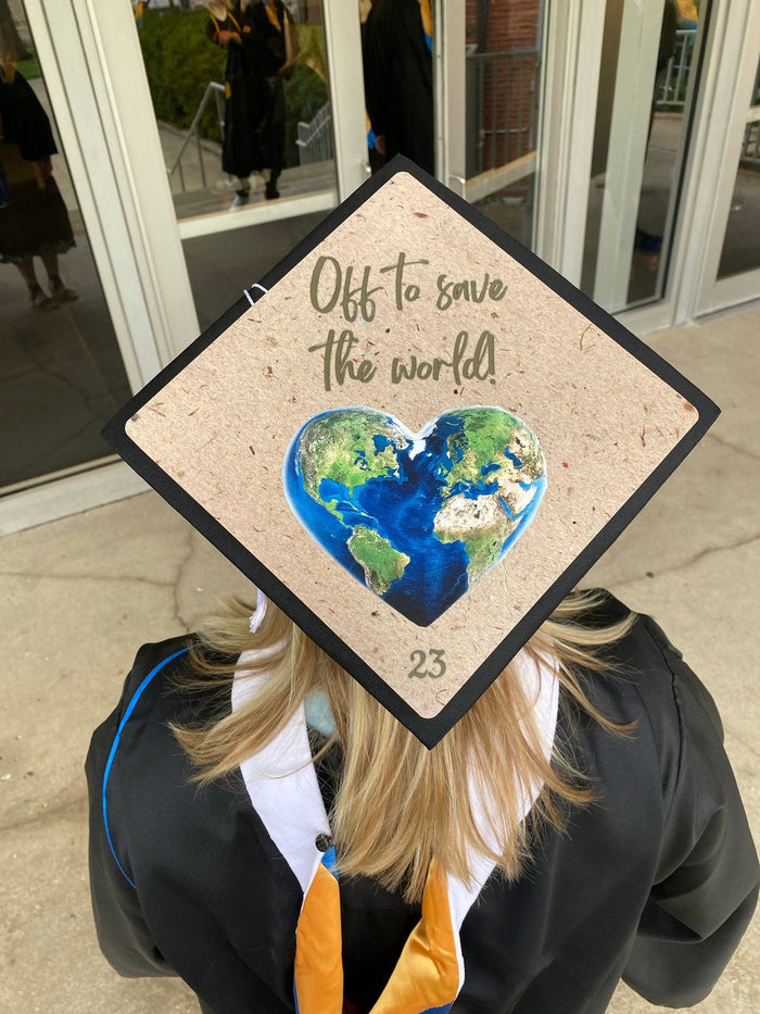 Graduate wearing Off To Save The World earth cap