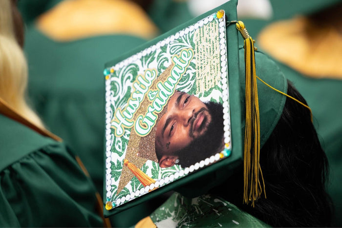 Graduate wearing Finally Graduated photo cap