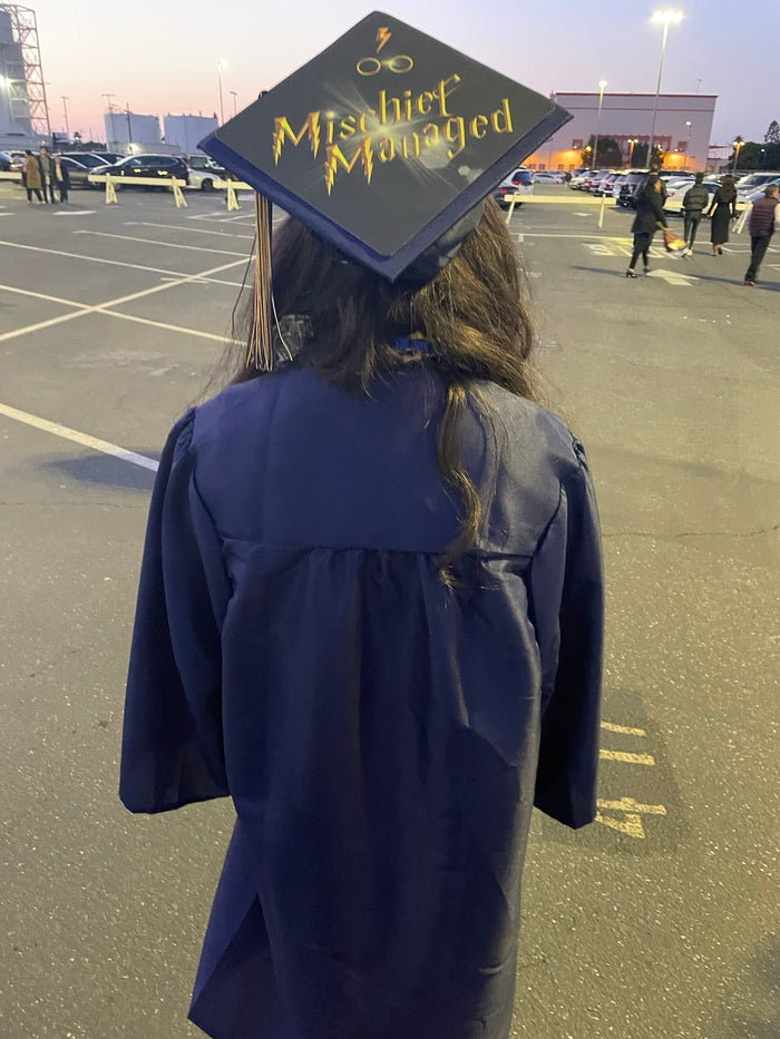 Graduate wearing Mischief Managed cap