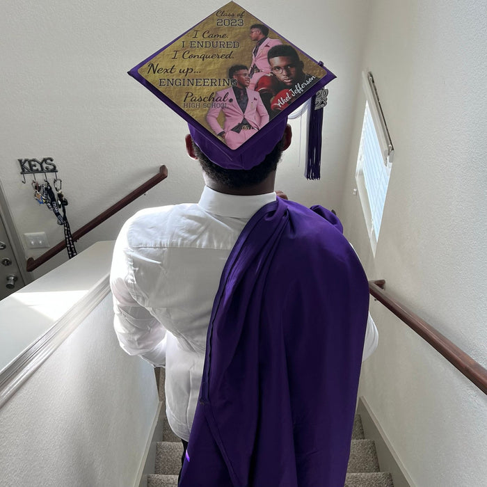 Graduate wearing photo collage cap on stairs
